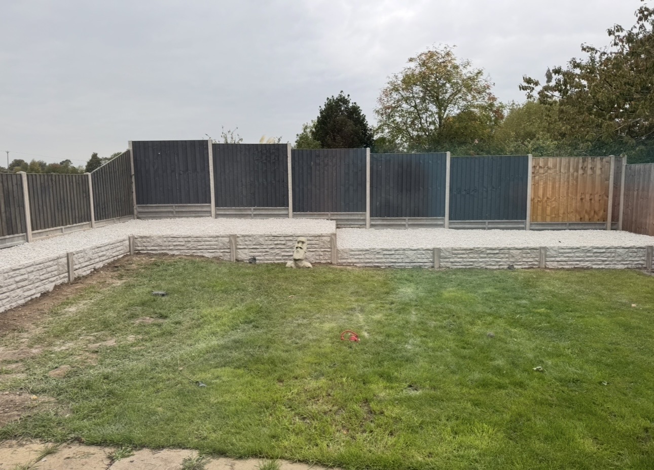 The garden after: a new retaining wall with fence panels behind it