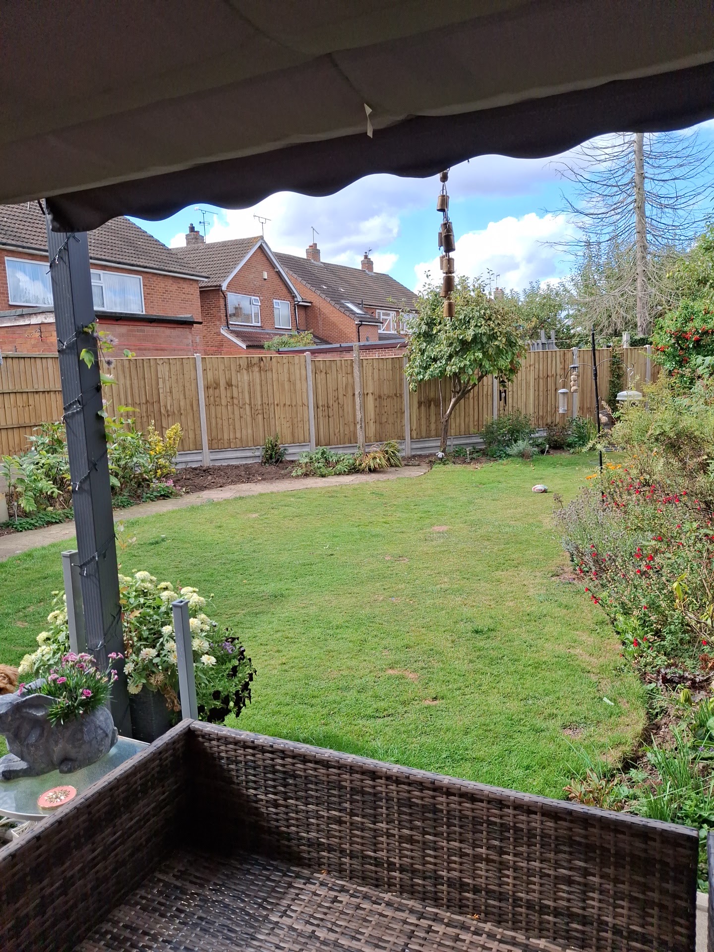 New fence panels along the back of a lawned garden
